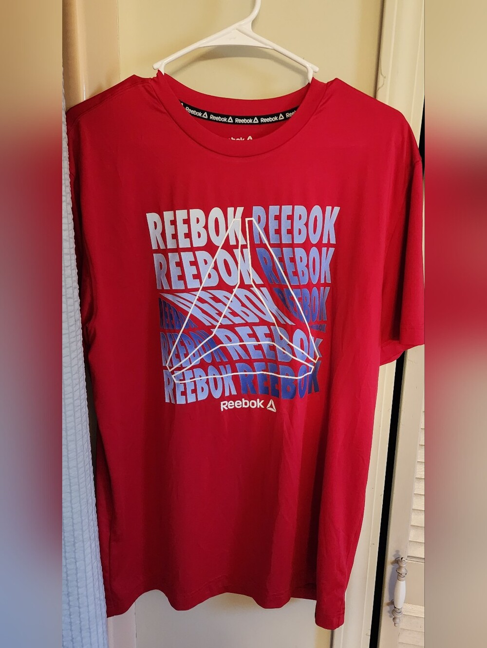 Reebok Men’s Red Graphic Logo Teeshirt  with Blue/White Writting Size Med